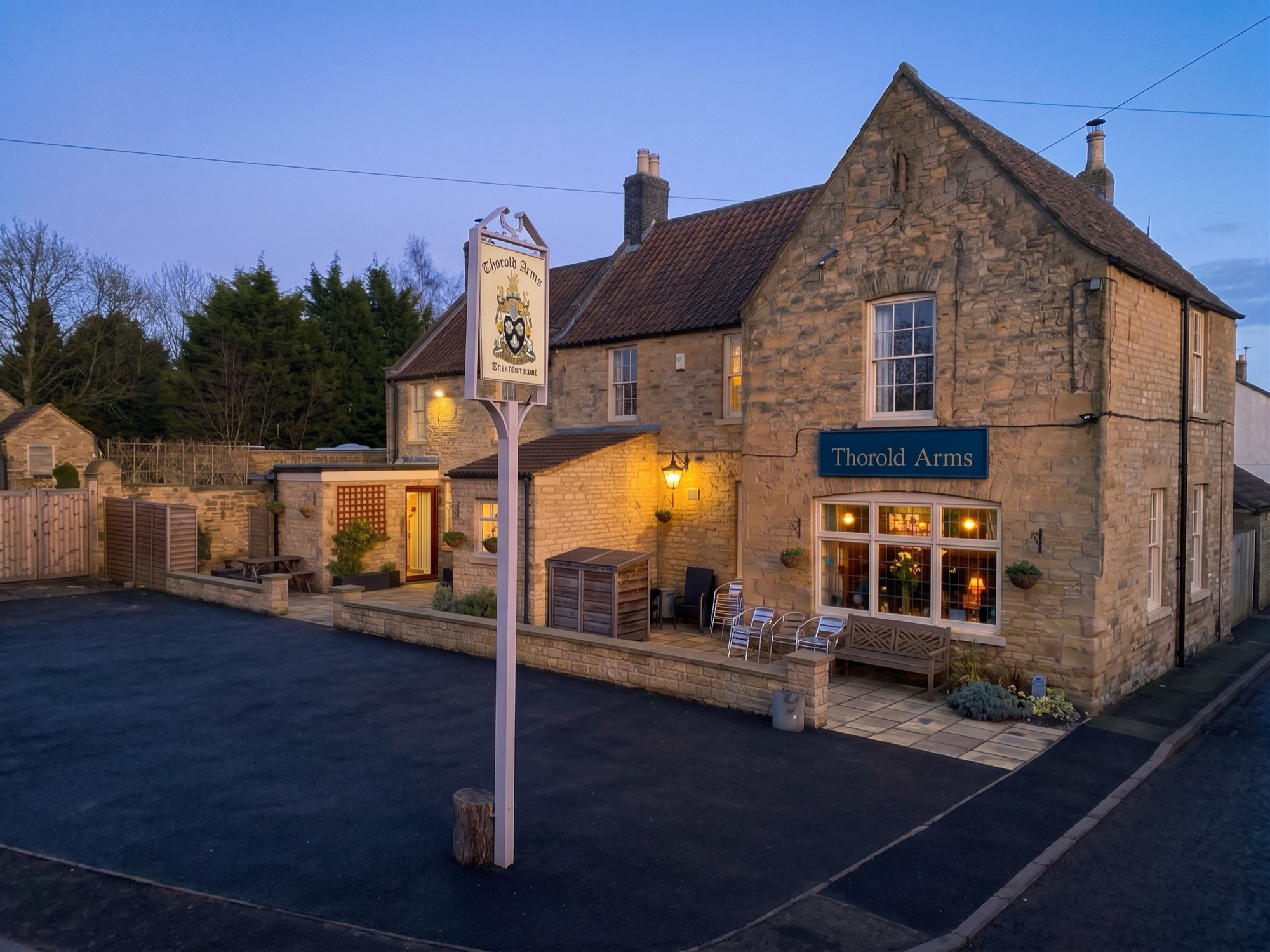 The Thorold Arms, Harmston, at dusk with the windows lit